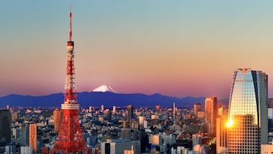skyline image of Tokyo with Mount Fuji far in the background and Tokyo Tower in the foreground.
